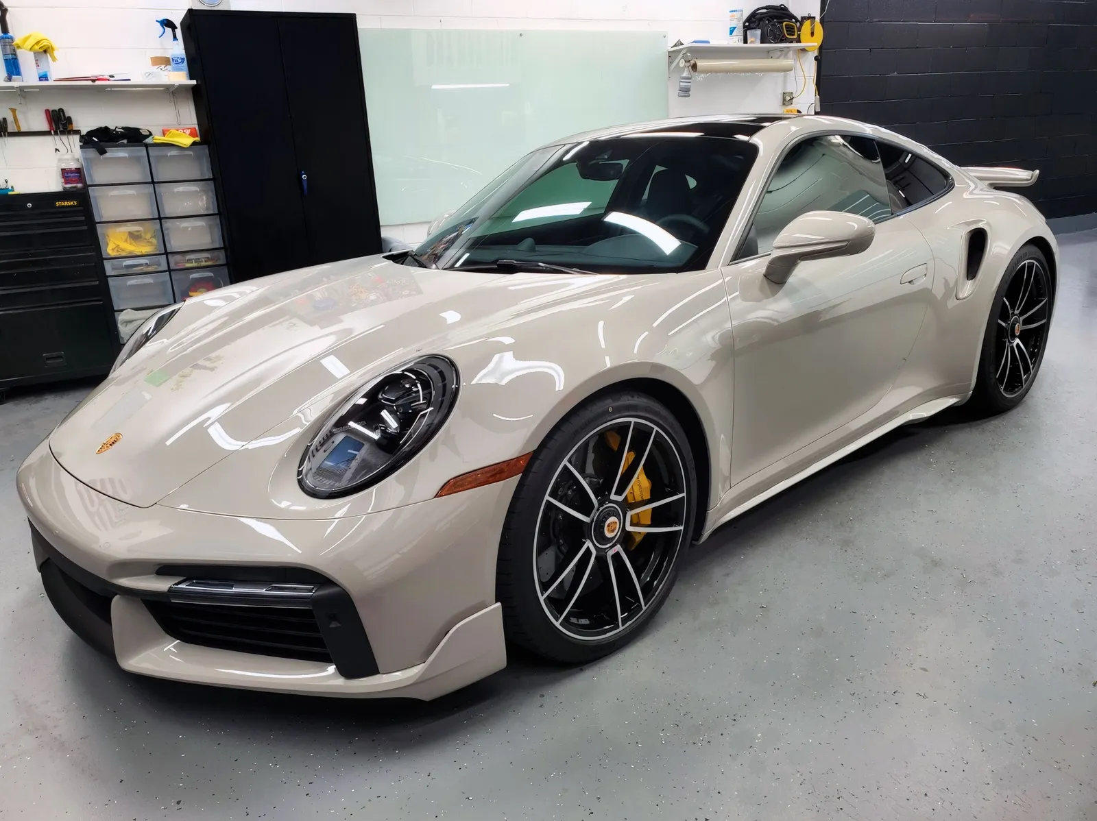 Chalk-white sports car in a detailing studio